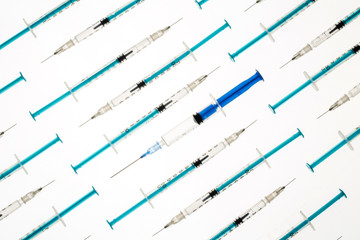 A lot of transparent medical syringes. Close up shot, white background.