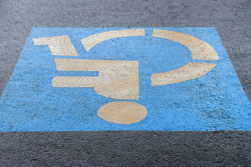 sign on asphalt parking for the disabled, close-up