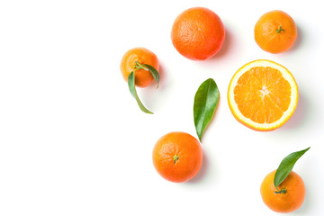 Bunch of ripe juicy organic oranges tangerines on branch with green leaves on white background. Top...