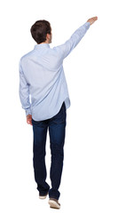 Back view of a man walking with a pointing hand.