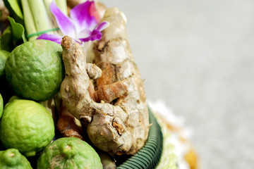 Crops of lime and ginger components in the oil and aroma of the Thai spa massage on blurry background with space for texts.