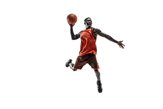 Full Length Portrait Of A Basketball Player With A Ball Isolated On White Studio Background. Advertising Concept. Fit African American Athlete Jumping With Ball. Motion, Activity, Movement Concepts.