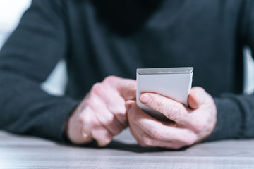 Male hands using a smartphone