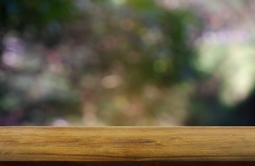 Empty wooden table in front of abstract blurred green of garden and nature light background. For montage product display or design key visual layout - Image