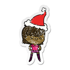 annoyed distressed sticker cartoon of a girl wearing santa hat