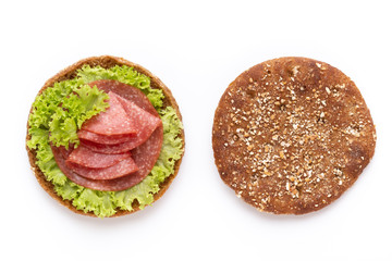 Sandwich with salami sausage on white background.