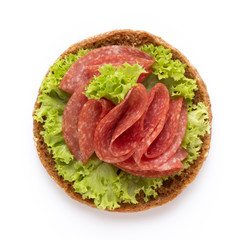 Sandwich with salami sausage on white background.