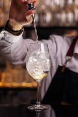 Hugo cocktail drink with ice cubes, mint and lemon