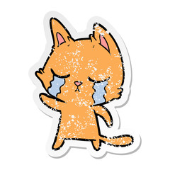 distressed sticker of a crying cartoon cat pointing