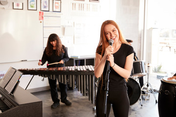 Students At Performing Arts School Playing In Band At Rehearsal