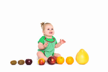 Fototapeta na wymiar Baby girl sitting with fruits and vegetables, isolated background