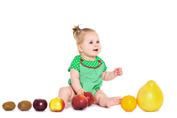 Fototapeta na wymiar Baby girl sitting with fruits and vegetables, isolated over white