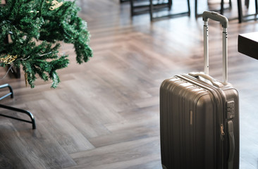 Large suitcases stand in the lobby of the hotel on the background.