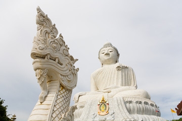 Fototapeta premium Sculpture of the big Sitting Buddha and the head of a dragon.