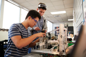 Two Male College Students Building Machine In Science Robotics Or Engineering Class