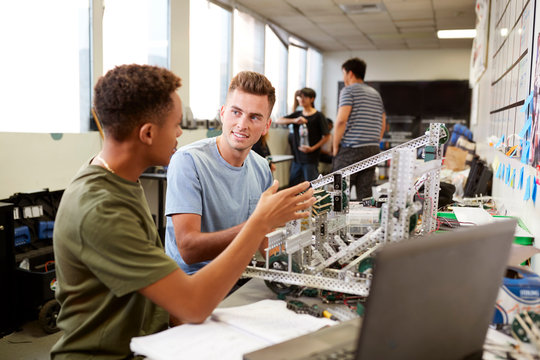 Two Male University Students Building Machine In Science Robotics Or Engineering Class