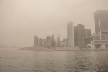 USA. New York City. Manhattan early in the morning. Thick fog. Embankment and skyscrapers.