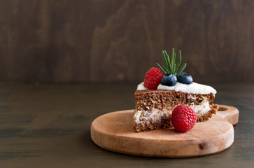 Homemade chocolate cake with raspberries and blueberries.
