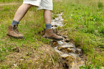 Hiker's leather shoe while crossing a brook