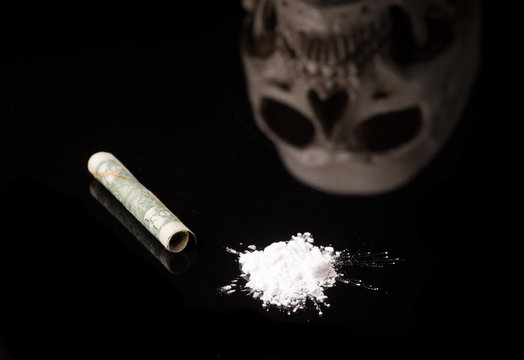 cocaine or other illegal drugs with glossy skull