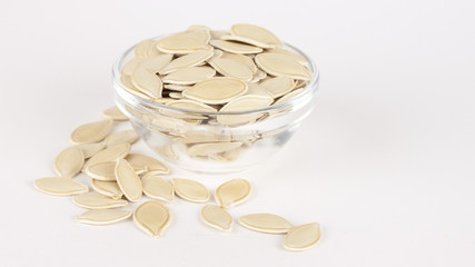 raw superfoods pumpkin seeds on white background
