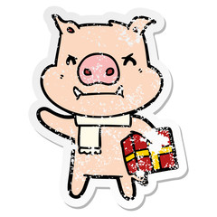 distressed sticker of a angry cartoon pig with christmas gift