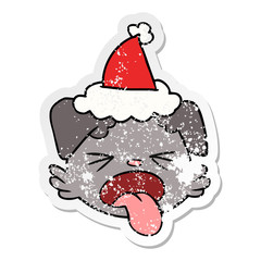 distressed sticker cartoon of a dog face wearing santa hat