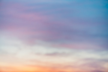 Sunset sky with violet yellow light clouds. Colorful smooth blue sky gradient. Natural background of sunrise. Amazing heaven at morning. Slightly cloudy evening atmosphere. Wonderful weather on dawn.