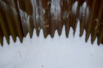 Corroded fence in the snow