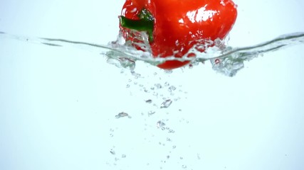 bright red bell pepper dipping in clear water on blue background with backlit - Powered by Adobe