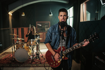 Fototapeta premium Music band having rehearsal in a studio