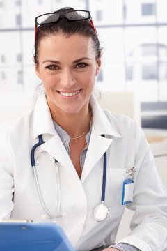 Portrait of happy female doctor at medical office