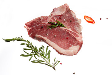 Raw meat steak with rosemary and herbs, isolate
