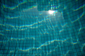 Blue rippled water in a swimming pool on a sunny day