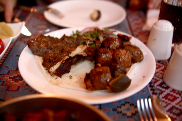 Azerbaijani Style Beef and Potato  Kebab on a Plate with Onions and Bread