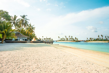 Amazing island in the Maldives ,water villa ,wooden bridge ,white sandy beach  and beautiful  turquoise waters with  blue sky  background for holiday vacation .