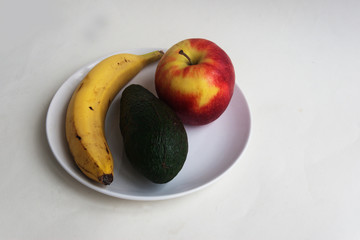 Fruits in a white plate. Candid.