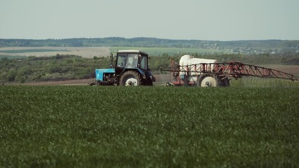Tractor With A Sprayer Work In The Field.
