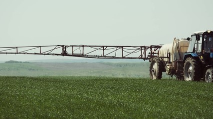 Tractor With A Sprayer Work In The Field.