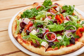 vegetarian pizza with fresh tomatoes, olives, tofu and red onion