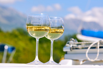 Pair of wineglasses against the yacht