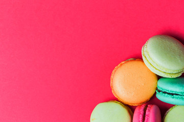 Fototapeta na wymiar Beautiful bright pink background with French pastry macaroons
