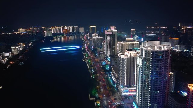 sanya cityscape night illumination riverside traffic bay aerial panorama 4k hainan china