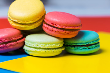 Fototapeta na wymiar Sweet and colourful french macaroons or macaron on colorful background. Delicious dessert
