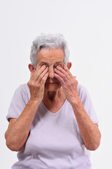 senior woman with eyes on white background