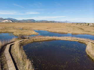 Aerial view of a wooden path over a swamp in the wetlands nature park La Marjal in Pego and Oliva, Spain.