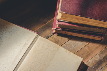 opened old book to blank page for text on wooden table, vintage tone