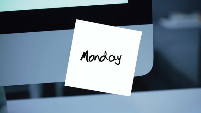 Monday. Days of the week. The inscription on the sticker on the monitor. Message. Motivation. Reminder. Handwritten text written with a marker. Color sticker. A message for an employee, a colleague