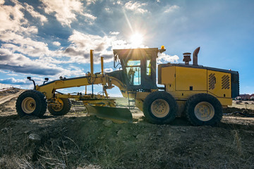 Excavator machine leveling the ground with a large shovel