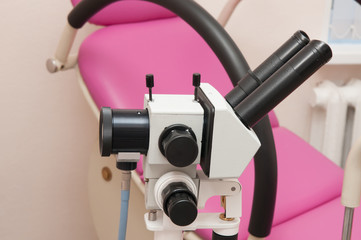 The colposcope on the background of gynecological chair
